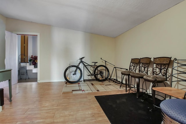 interior space featuring a textured ceiling and light wood-type flooring