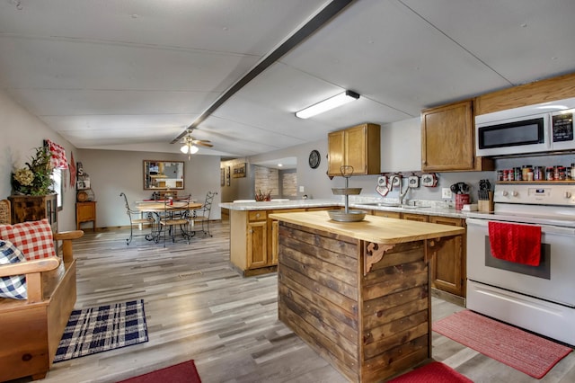 kitchen with vaulted ceiling, a kitchen island, sink, white electric range oven, and light wood-type flooring