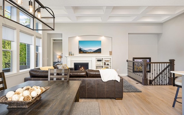 living room featuring coffered ceiling, beam ceiling, and light wood-type flooring