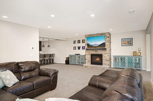 living room featuring a stone fireplace and carpet floors