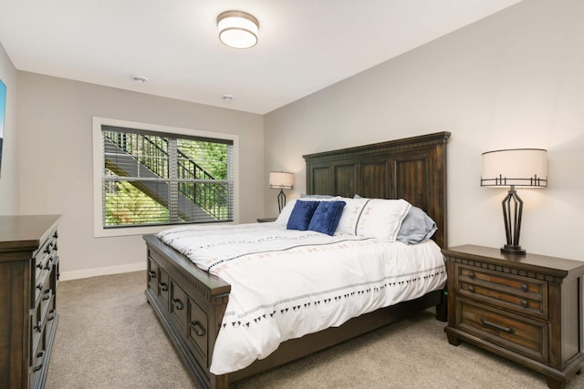 bedroom featuring light colored carpet