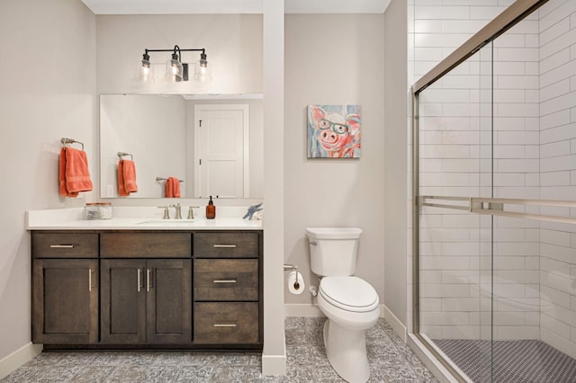 bathroom with vanity, toilet, and an enclosed shower