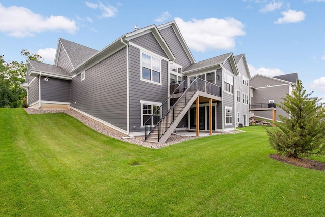 rear view of house featuring a yard, a deck, and a sunroom