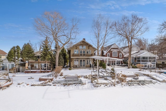 view of snow covered rear of property