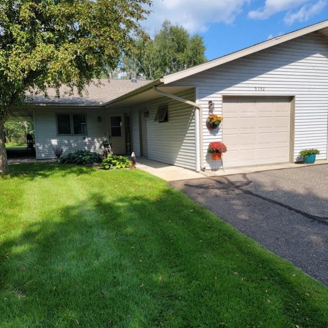 single story home with a garage and a front yard