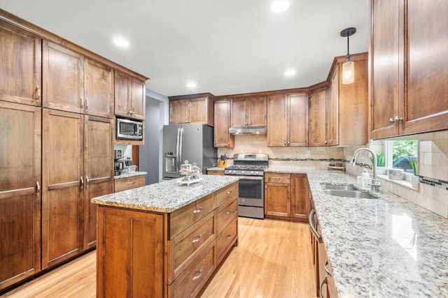 8224 Morris Rd, Bloomington, MN 55437 - kitchen featuring appliances with stainless steel finishes, under cabinet range hood, light wood-type flooring, backsplash, and recessed lighting