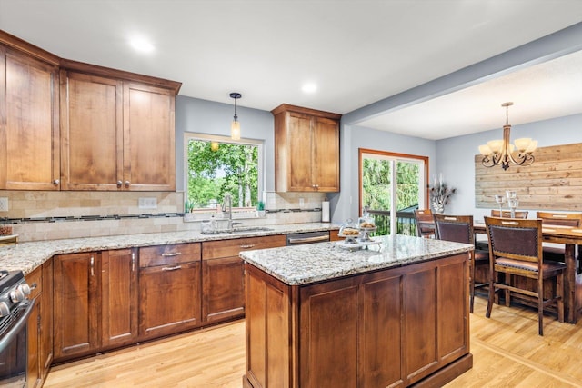 8224 Morris Rd, Bloomington, MN 55437 - kitchen with appliances with stainless steel finishes, light wood-style floors, backsplash, brown cabinetry, and a chandelier