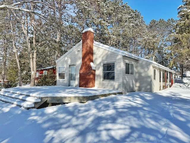 view of snowy exterior featuring a deck