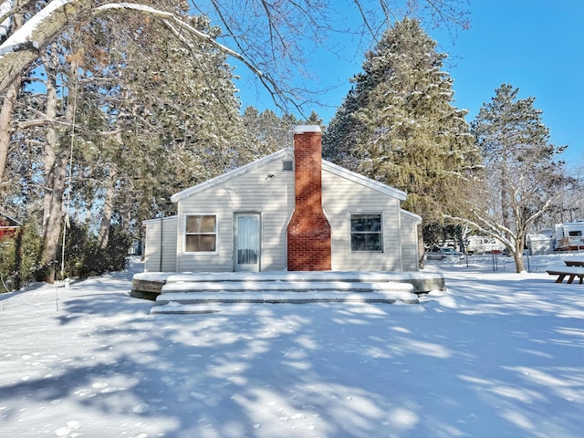 view of snow covered rear of property