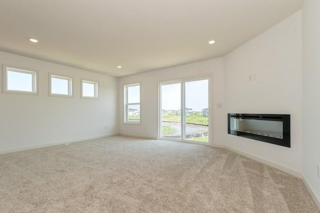 unfurnished living room featuring light colored carpet