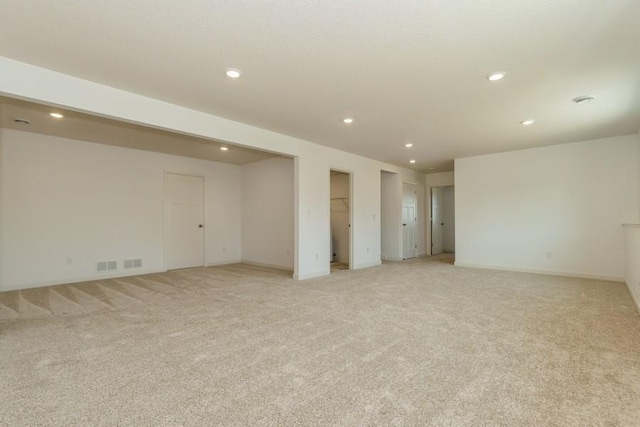 basement featuring light carpet