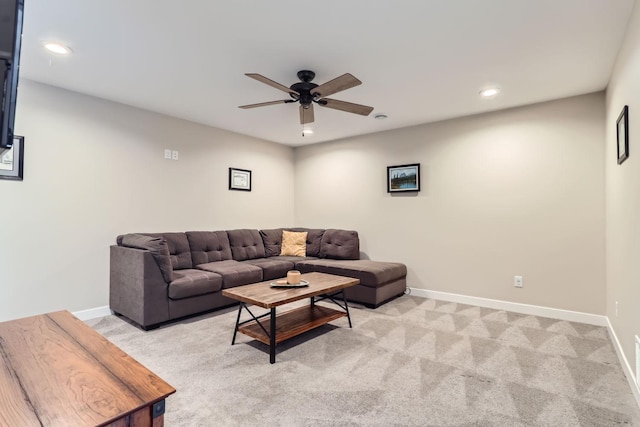 carpeted living room with ceiling fan