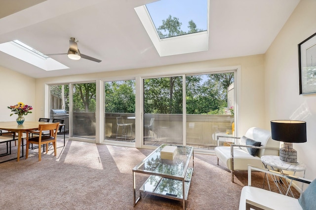 sunroom featuring ceiling fan, plenty of natural light, and lofted ceiling with skylight