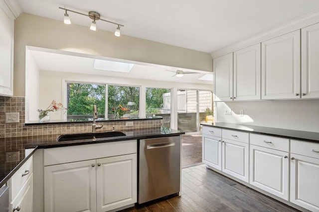 kitchen with white cabinetry, dishwasher, sink, and a skylight