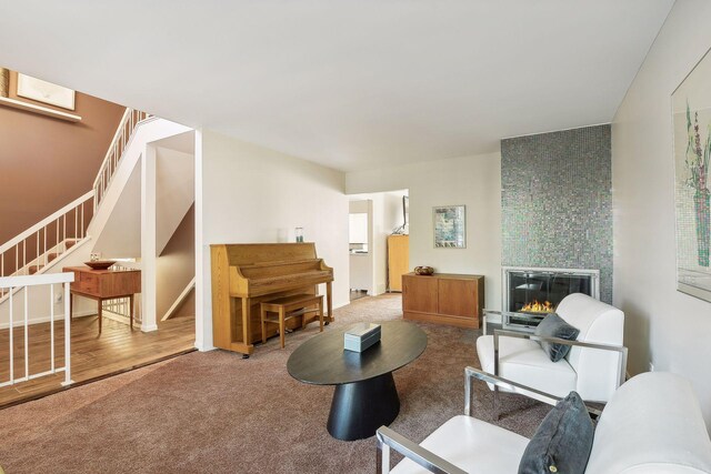 living room featuring a fireplace and carpet