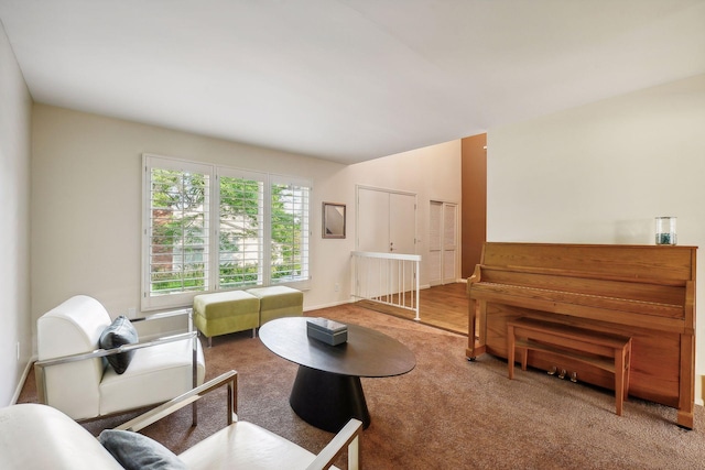 carpeted living room featuring lofted ceiling