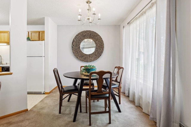 carpeted dining area with sink and a chandelier