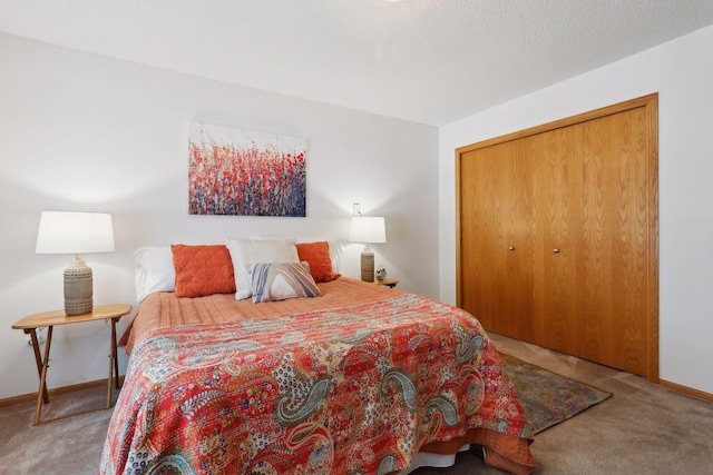 carpeted bedroom featuring a textured ceiling and a closet