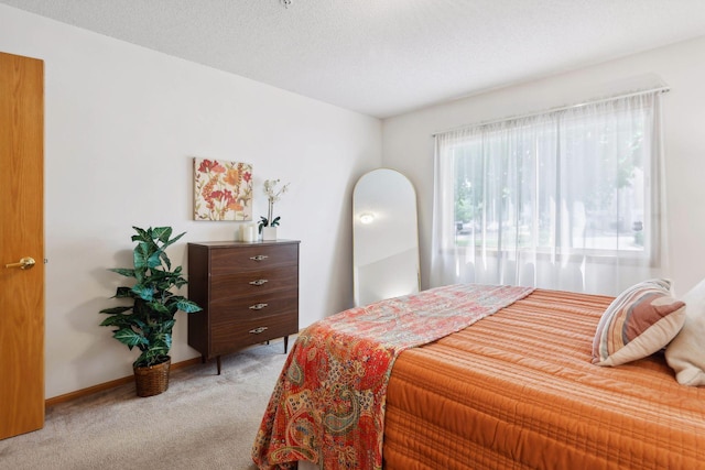 carpeted bedroom with a textured ceiling