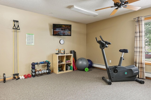 exercise area featuring baseboard heating, ceiling fan, a textured ceiling, and carpet