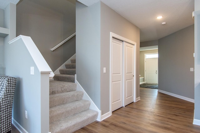 stairs with hardwood / wood-style flooring