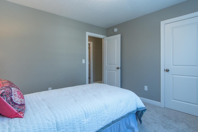 carpeted bedroom with a textured ceiling