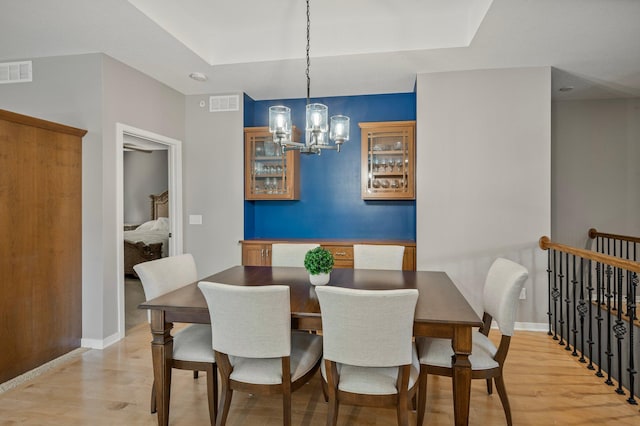 17365 Hanson Ct, Eden Prairie, MN 55347 - dining space with light wood finished floors, a chandelier, and baseboards