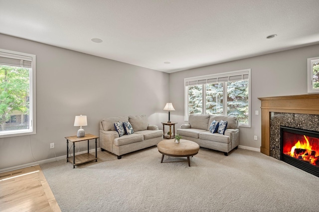 17365 Hanson Ct, Eden Prairie, MN 55347 - carpeted living room featuring healthy amount of natural light, a high end fireplace, and baseboards