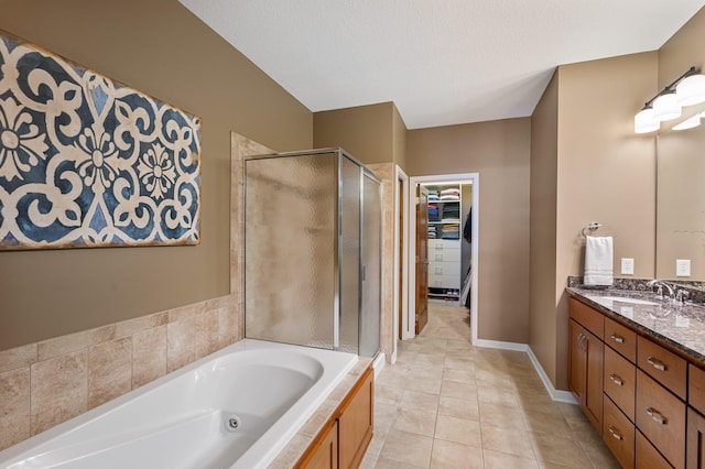 17365 Hanson Ct, Eden Prairie, MN 55347 - bathroom with a stall shower, vanity, a whirlpool tub, tile patterned floors, and a spacious closet