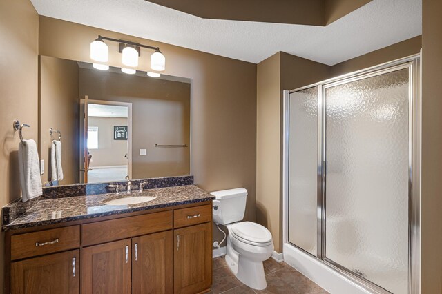 17365 Hanson Ct, Eden Prairie, MN 55347 - bathroom with a stall shower, toilet, tile patterned flooring, and vanity