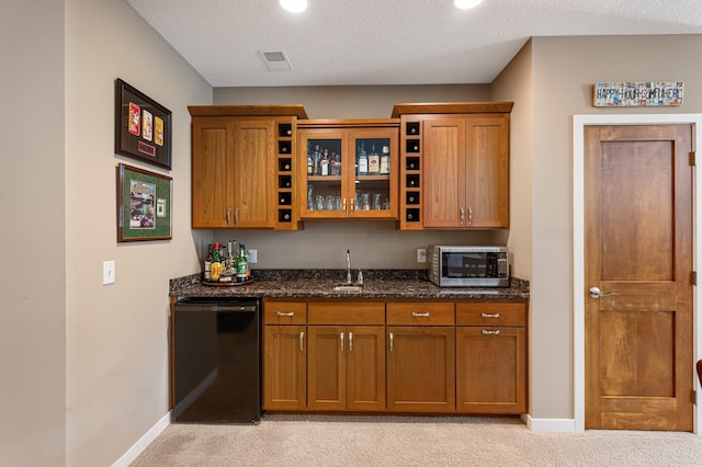 17365 Hanson Ct, Eden Prairie, MN 55347 - kitchen featuring black dishwasher, stainless steel microwave, light carpet, brown cabinets, and baseboards