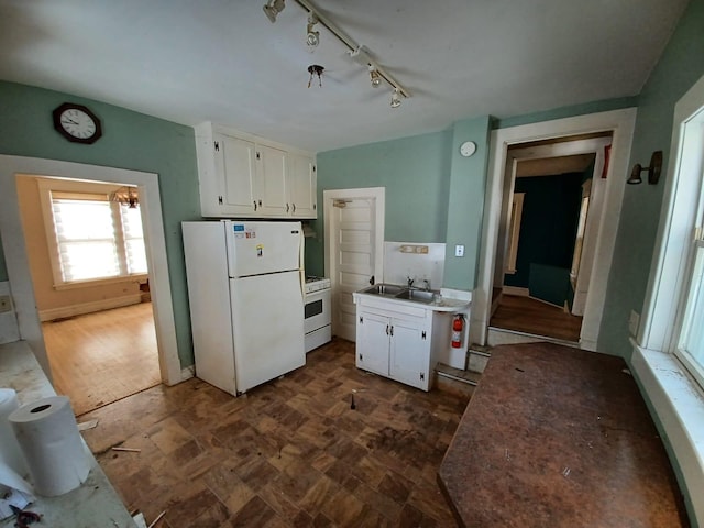 kitchen with white cabinetry, sink, and white appliances