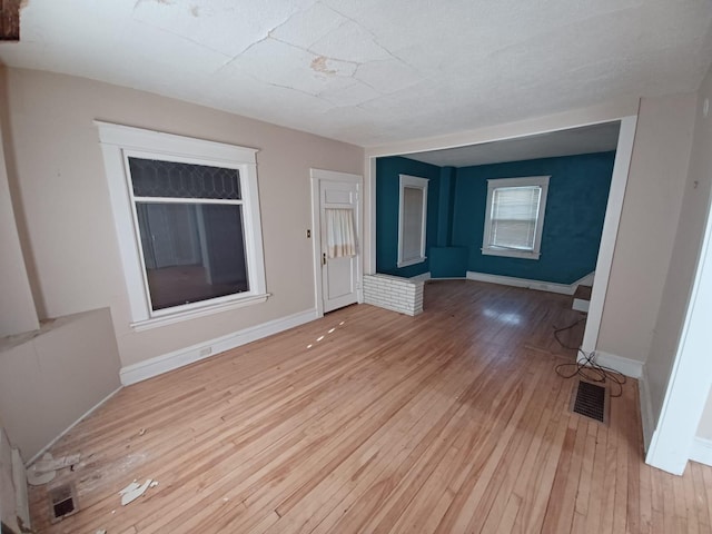 unfurnished living room featuring light wood-type flooring