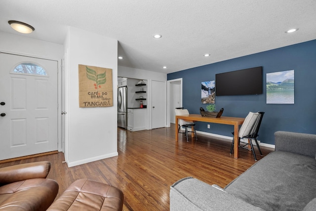 living room with dark wood-type flooring, recessed lighting, and baseboards