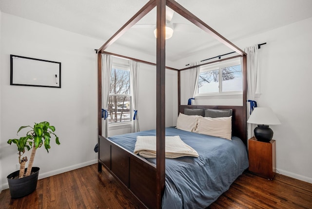 bedroom with multiple windows, baseboards, and dark wood-style flooring