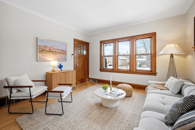 living room featuring wood-type flooring and ornamental molding