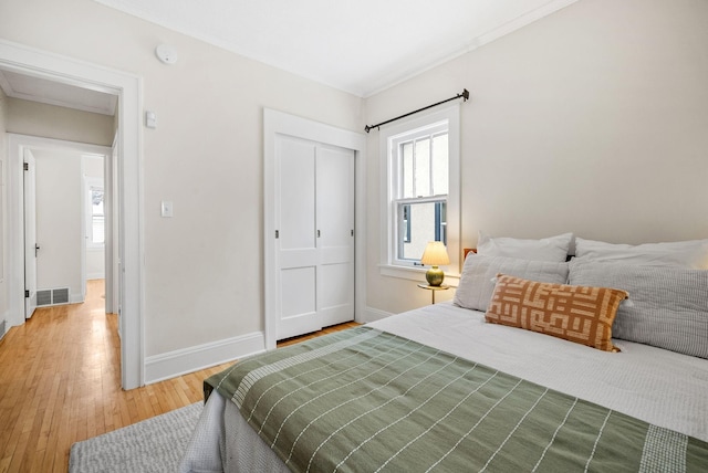 bedroom with hardwood / wood-style floors and a closet