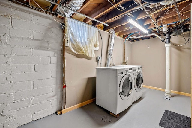 clothes washing area with washing machine and clothes dryer