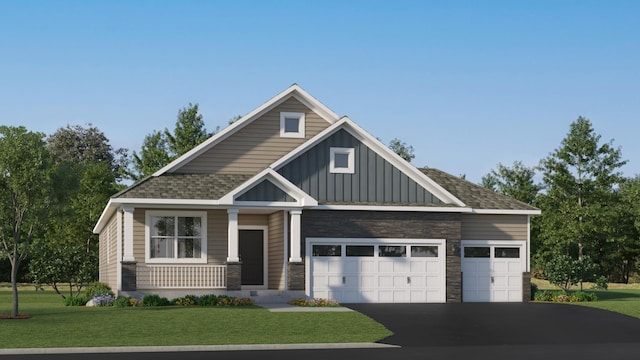 craftsman inspired home featuring a garage and a front lawn