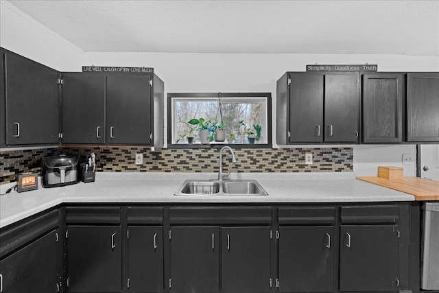 kitchen with sink, decorative backsplash, and a textured ceiling