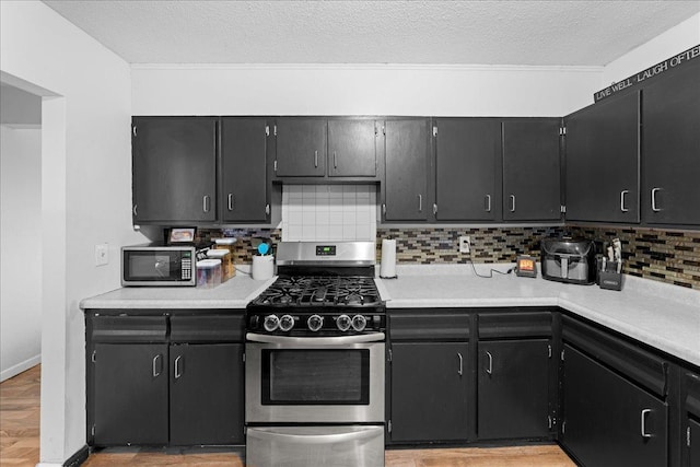 kitchen with stainless steel appliances, tasteful backsplash, and a textured ceiling