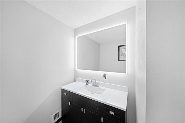 bathroom featuring vanity and a textured ceiling