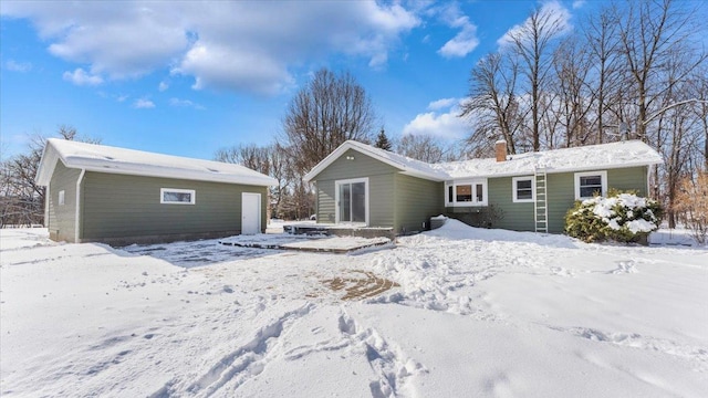 view of snow covered rear of property