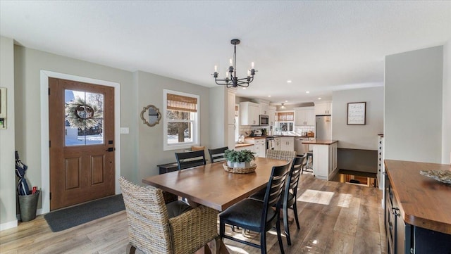 dining area featuring an inviting chandelier and light wood-type flooring