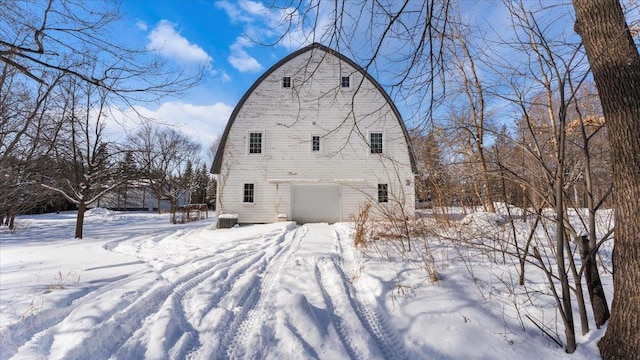 snow covered house with a garage