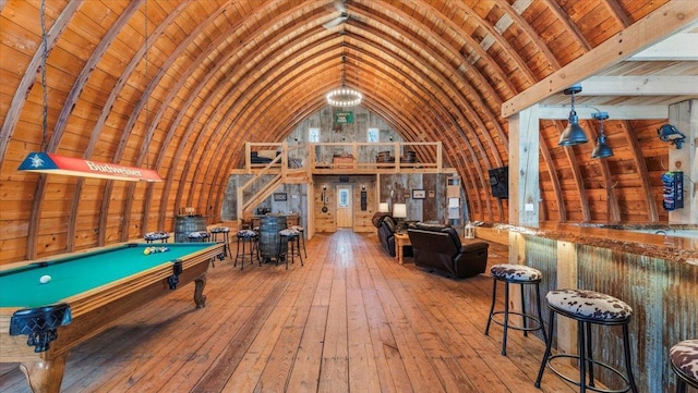 playroom with lofted ceiling, wood ceiling, pool table, bar area, and hardwood / wood-style flooring