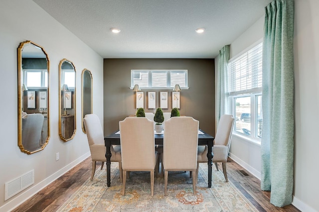 dining space with wood-type flooring