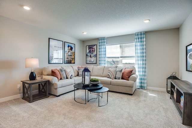 living room featuring light colored carpet and a textured ceiling