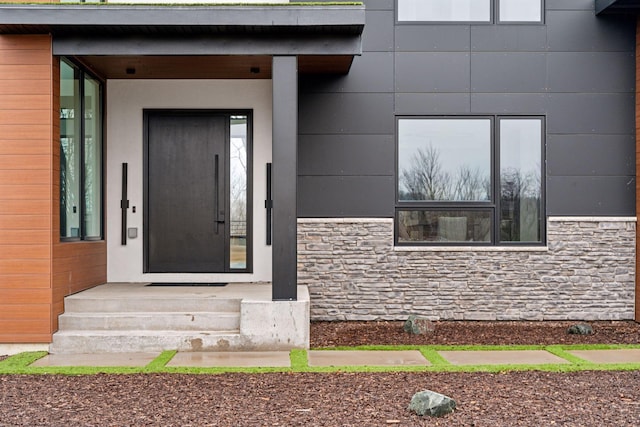 property entrance with stone siding