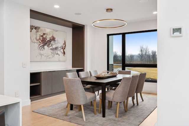 dining room with light wood finished floors and recessed lighting